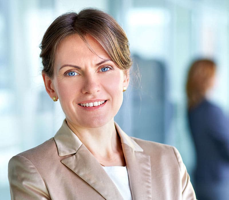 Smiling professional woman in business attire.