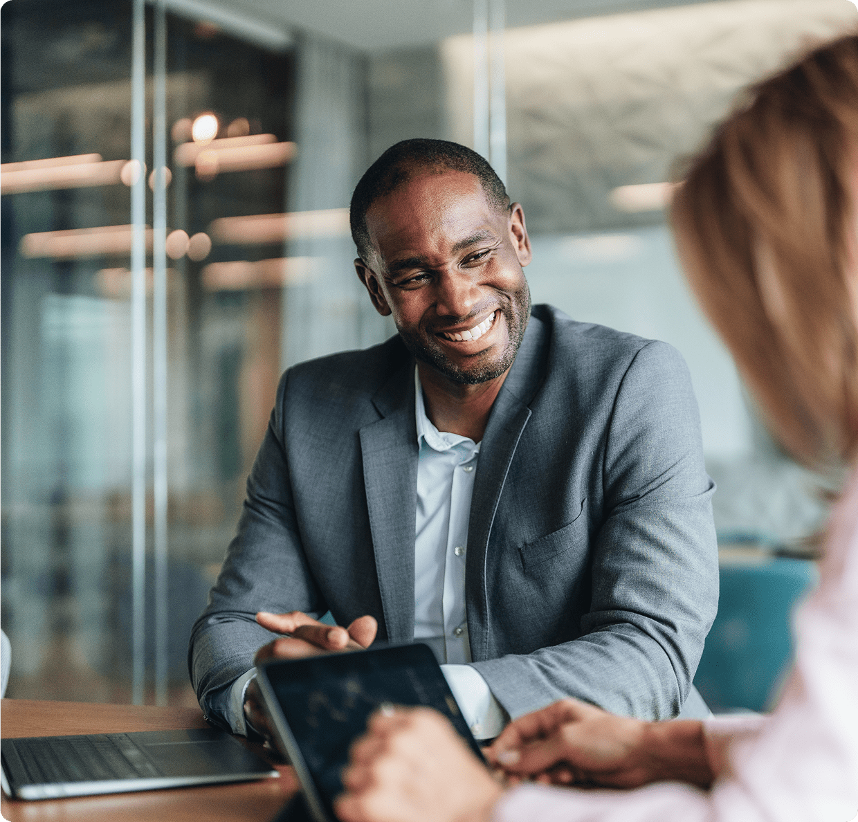 Man smiling during a business meeting discussion.