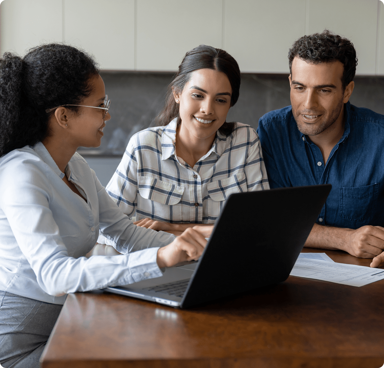 People collaborating around a laptop.