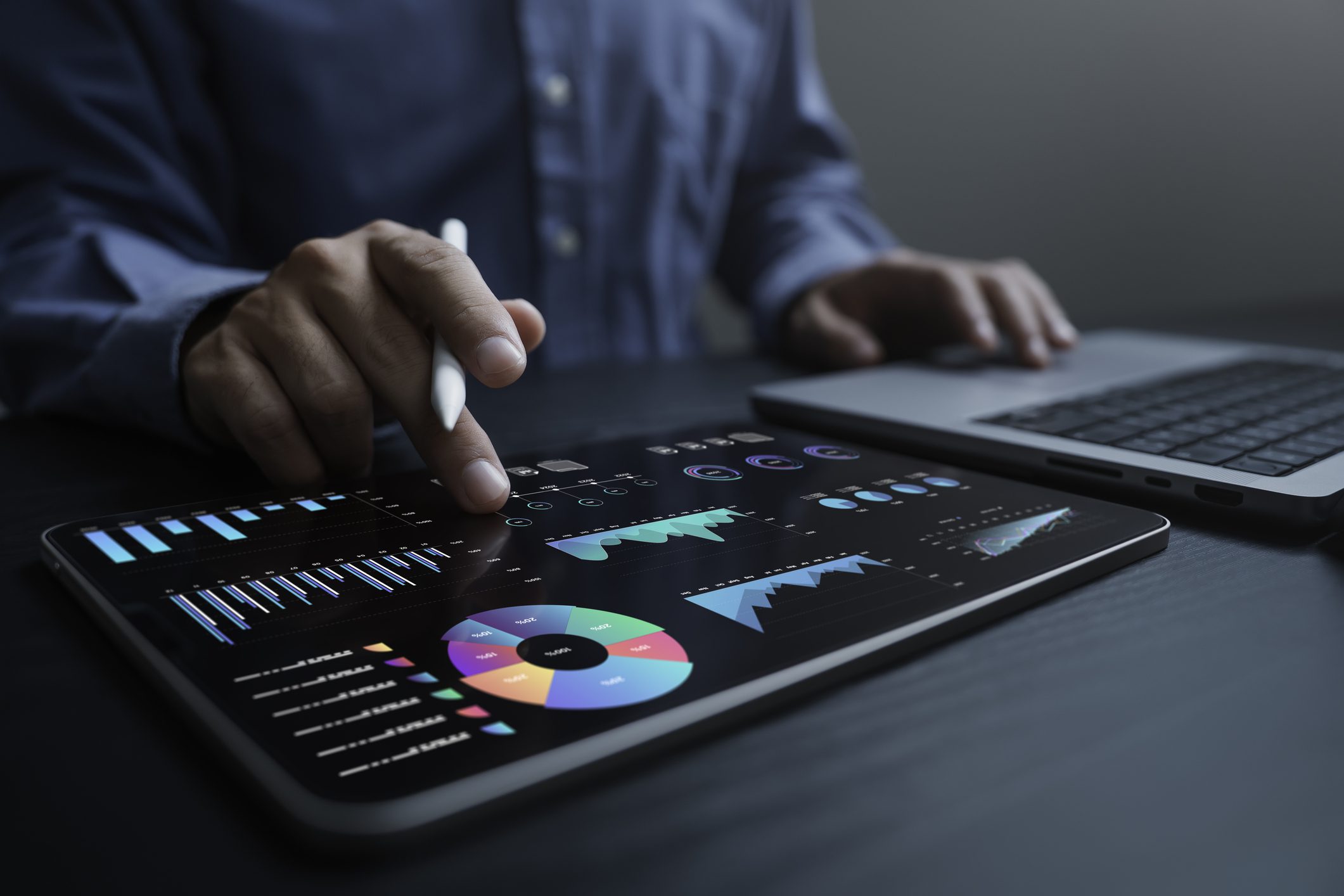 An analyst uses a computer and dashboard for data business analysis and Data Management System with KPI and metrics connected to the database for technology finance, operations, sales, marketing